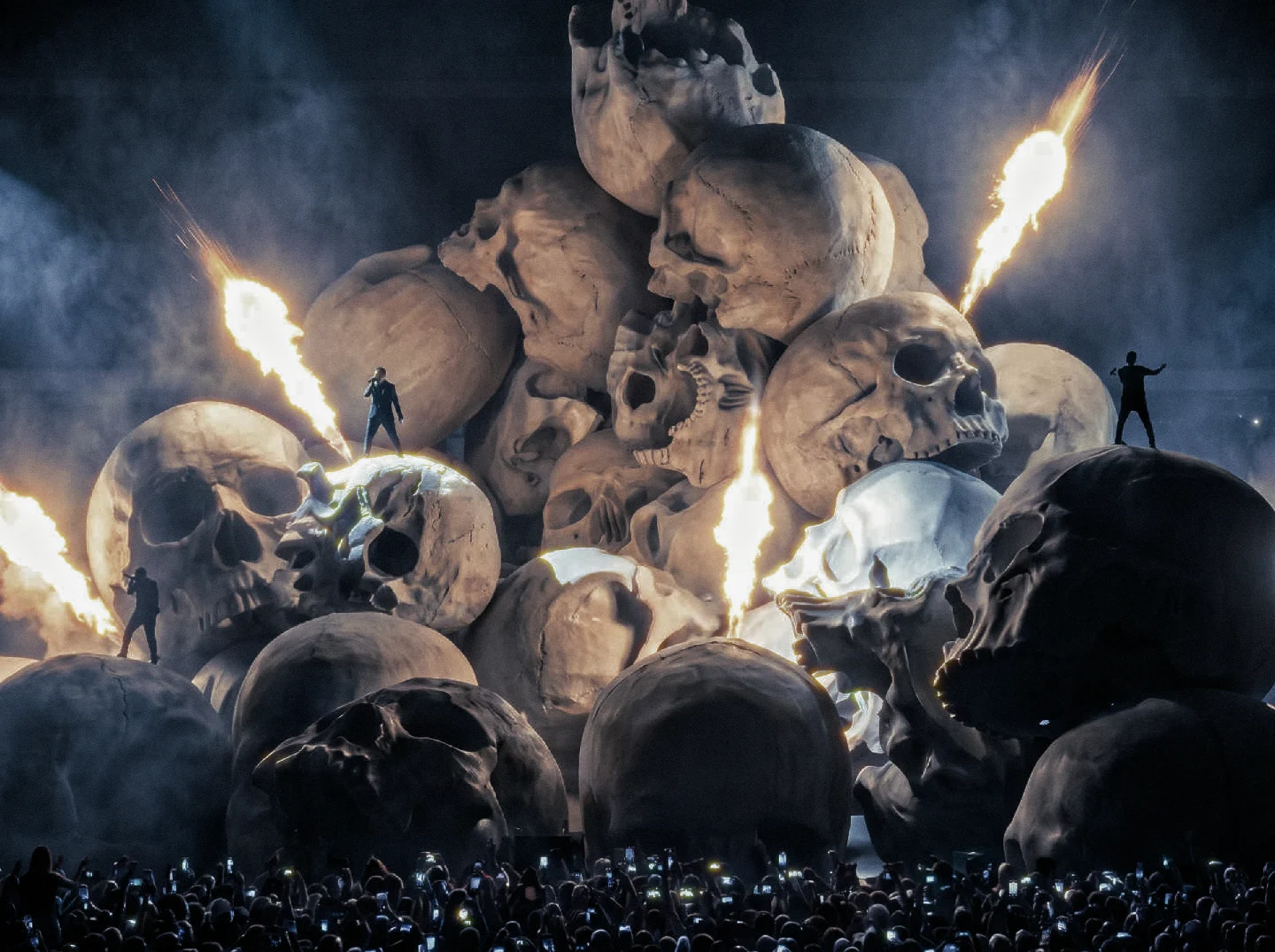 Stage of giant skulls with pyrotechnics above a crowd