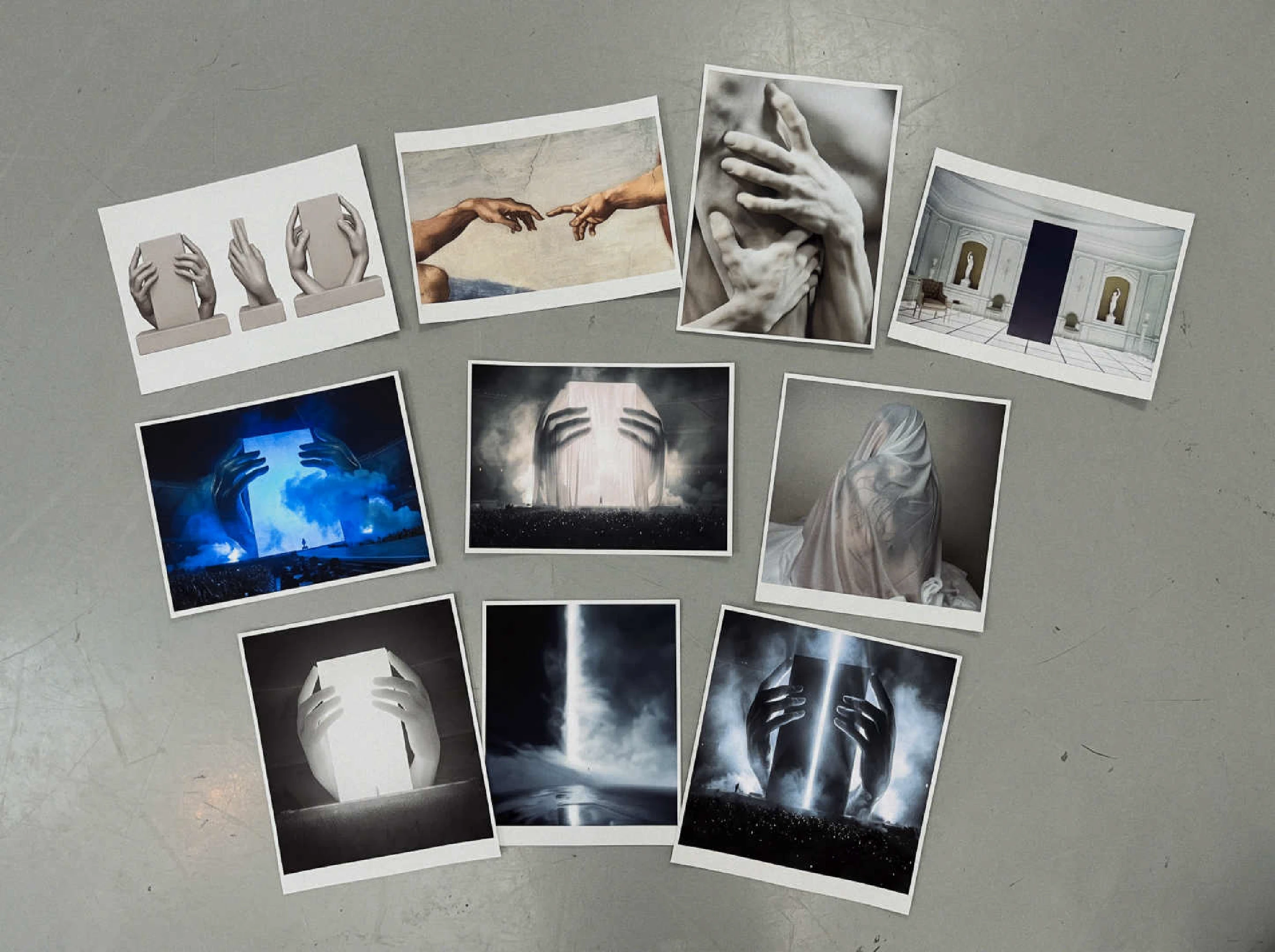 Printed references for the hands stage concept laid out on a studio floor